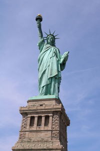 Low angle view of statue against blue sky