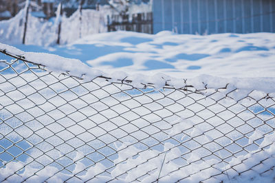 Fence covered in snow during winter