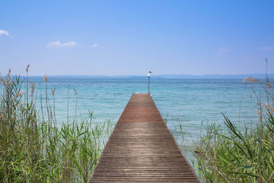 Scenic view of sea against sky, a path into water at lazise italy