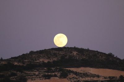 Low angle view of moon against clear sky at night