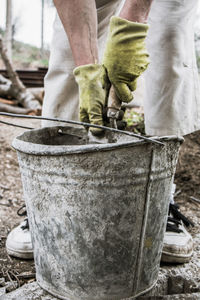 Low section of man working in container