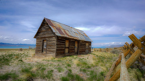 Old ruin on field against sky