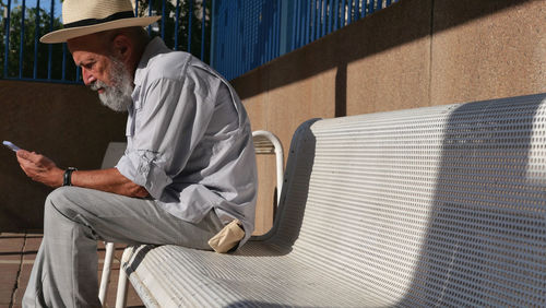 Senior man using mobile phone outdoor 