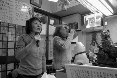 Mother and daughter standing at store