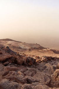 Scenic view of arid landscape against sky