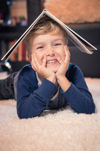 Portrait of smiling boy sitting outdoors