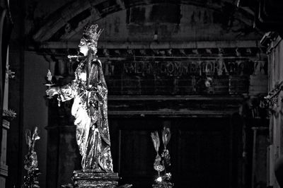 Low angle view of statue against temple at night