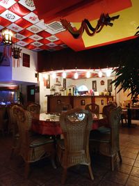 Empty chairs and tables in restaurant at night