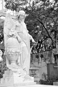 Statue against trees