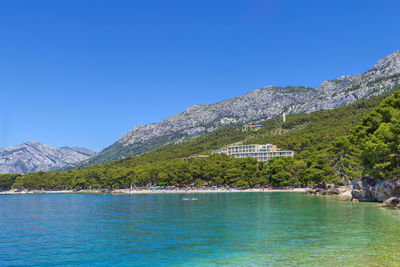 View of the shore of the adriatic sea with mountains in the background in district of brela, croatia