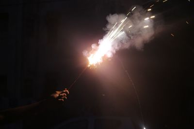 Low angle view of firework display at night