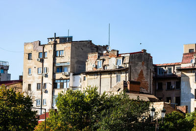 Low angle view of buildings against clear blue sky