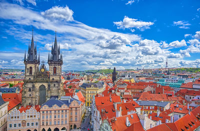 Buildings in city against cloudy sky