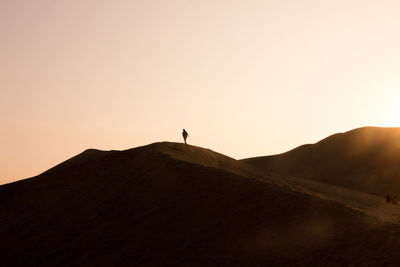 Scenic view of landscape against clear sky at sunset