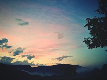 Low angle view of silhouette mountain against sky at sunset