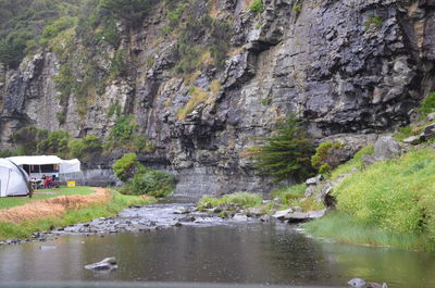 Scenic view of river by rocky mountains