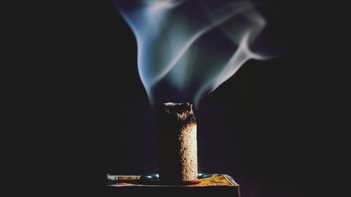Close-up of smoke stack against black background