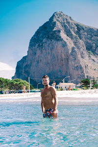 Full length of shirtless man in swimming pool