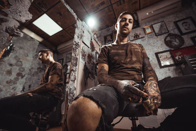Full length of man holding tattoo machine