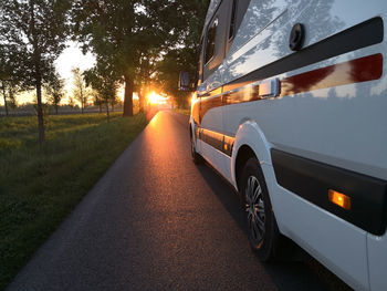 Cars on road at sunset