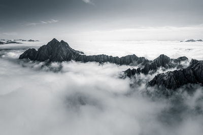 Mountain peaks rising above a sea of clouds, lienz, austria.