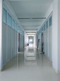 Mid distance view of young man sitting in corridor