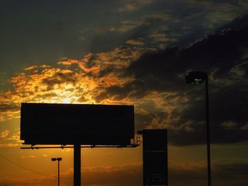 Low angle view of road sign against sky