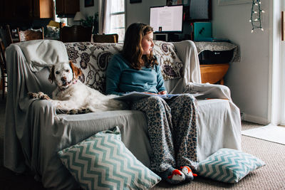 Girl and her dog sitting on the couch