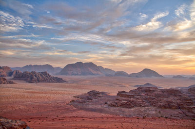 Scenic view of desert against sky during sunset