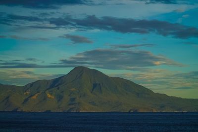 Scenic view of mountains against cloudy sky