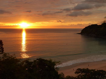 Scenic view of sea against orange sky