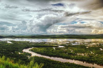 Scenic view of landscape against cloudy sky