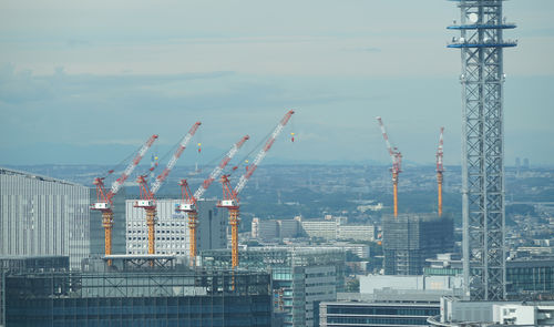 Port unloading crane seen from a high-rise building in yokohama port city, japan