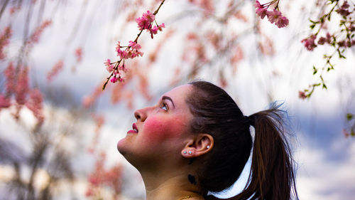 Smiling woman looking at flowers