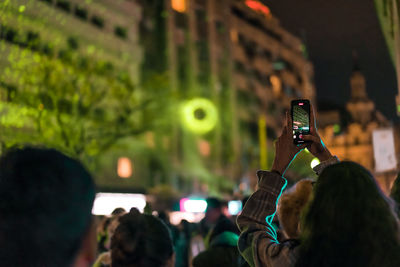 People taking photos in the city at night