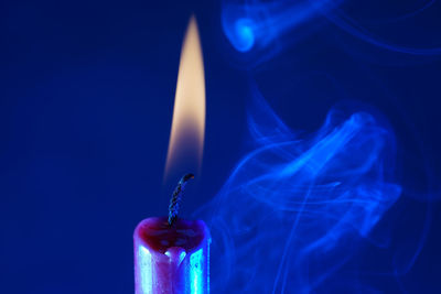 Close-up of human hand against blue background