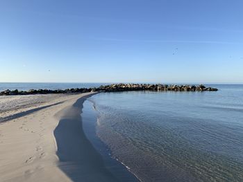 Scenic view of sea against clear blue sky