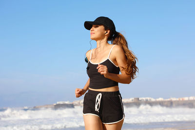 Young woman jogging at beach