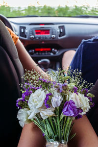 Midsection of woman holding bouquet