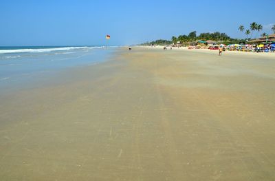 Scenic view of beach against blue sky
