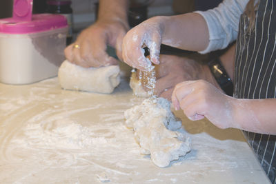 Cropped image of people making food at bakery