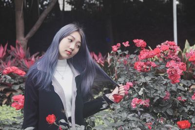 Portrait of beautiful young woman with flowers