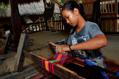 Girl working with handloom