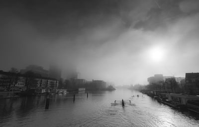 Panoramic view of river and cityscape against sky