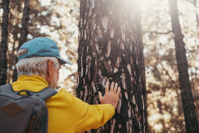 Rear view of man standing in forest