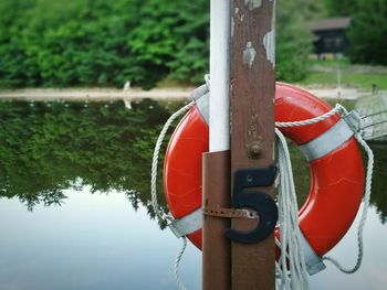 Close-up of red boat moored in water