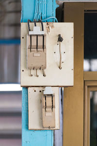 Close-up of telephone booth against wall