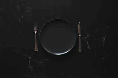 High angle view of coffee cup against black background