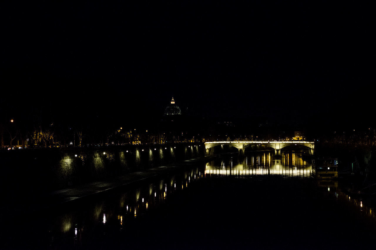 BRIDGE OVER RIVER AT NIGHT