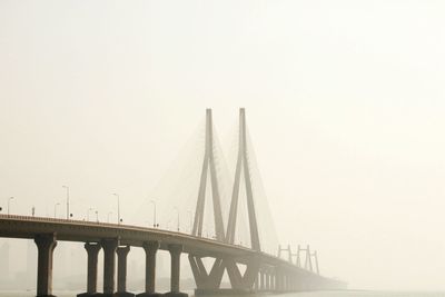 Low angle view of bridge against sky in city